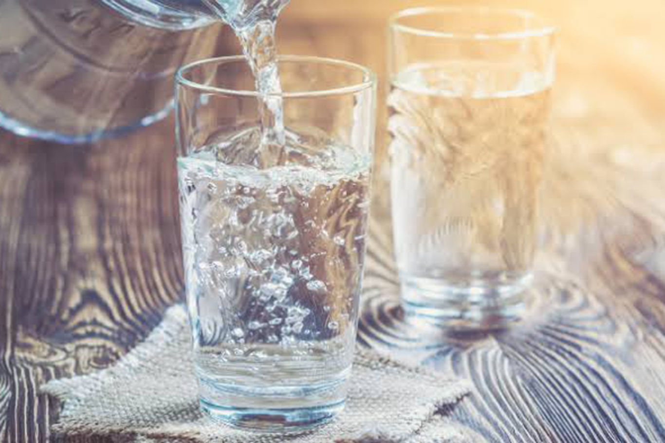 The dangers of drinking water in the summer sun; photo with pitcher and glass.